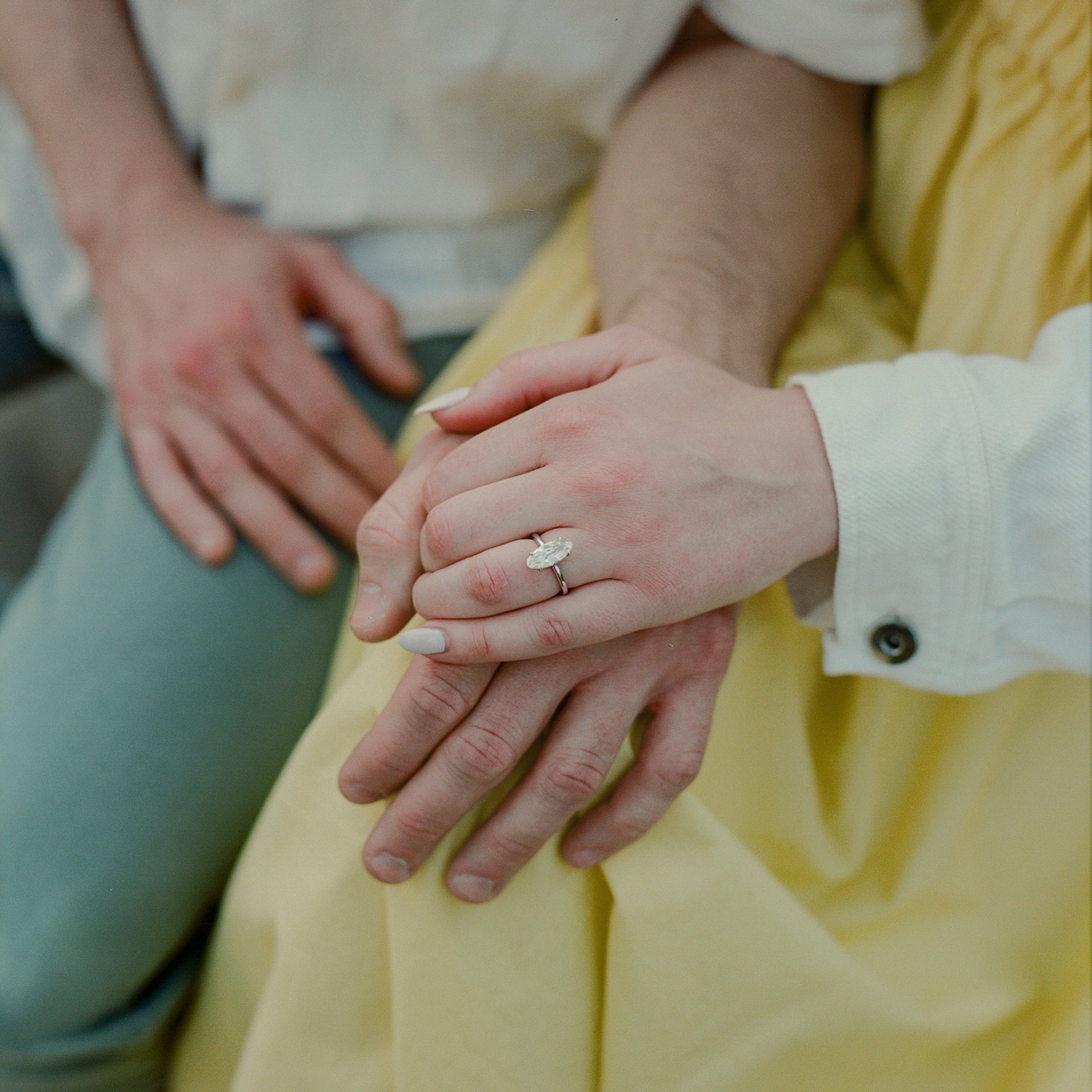 Close-up of two hands holding each other with a blurred background