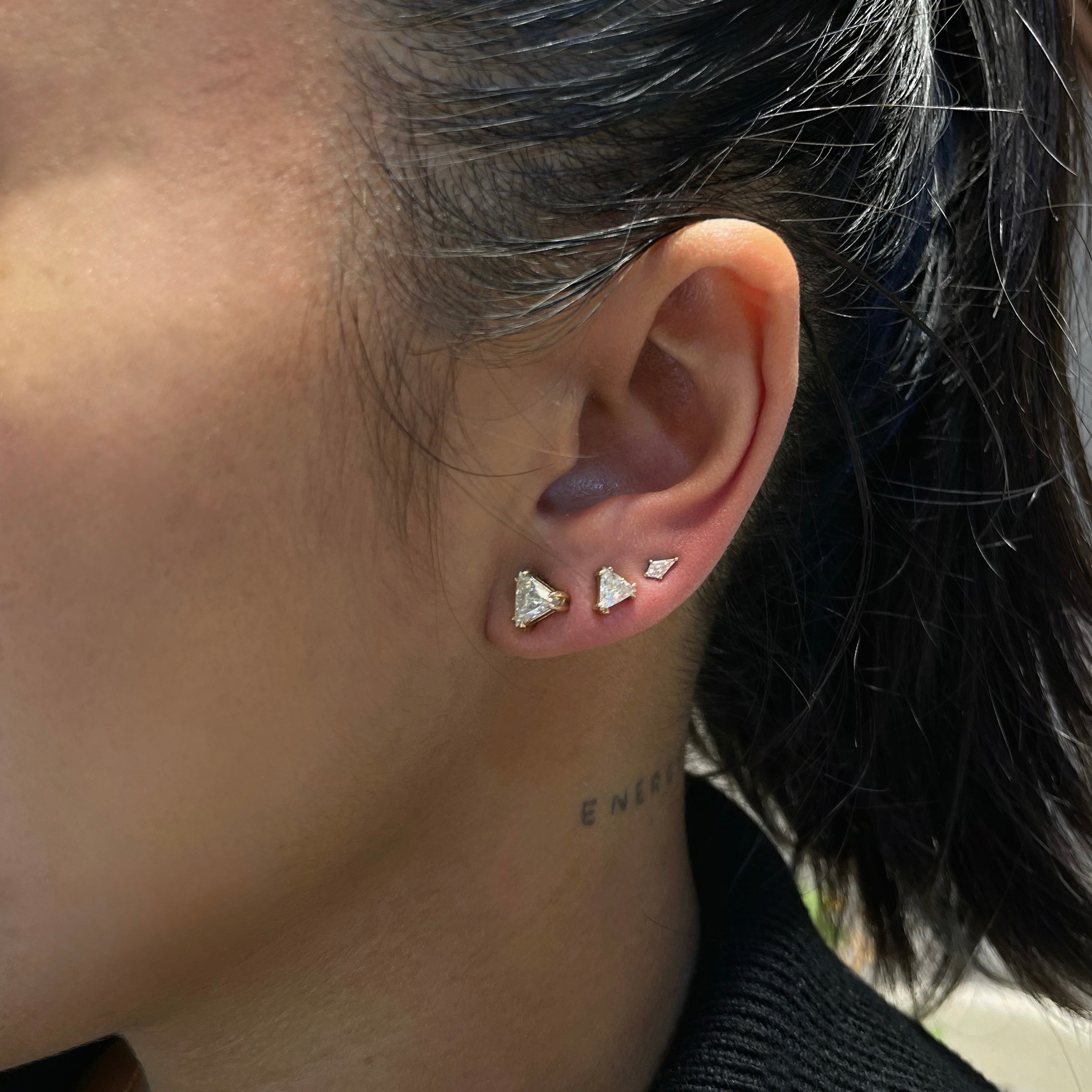 ear with 3 white diamond earrings