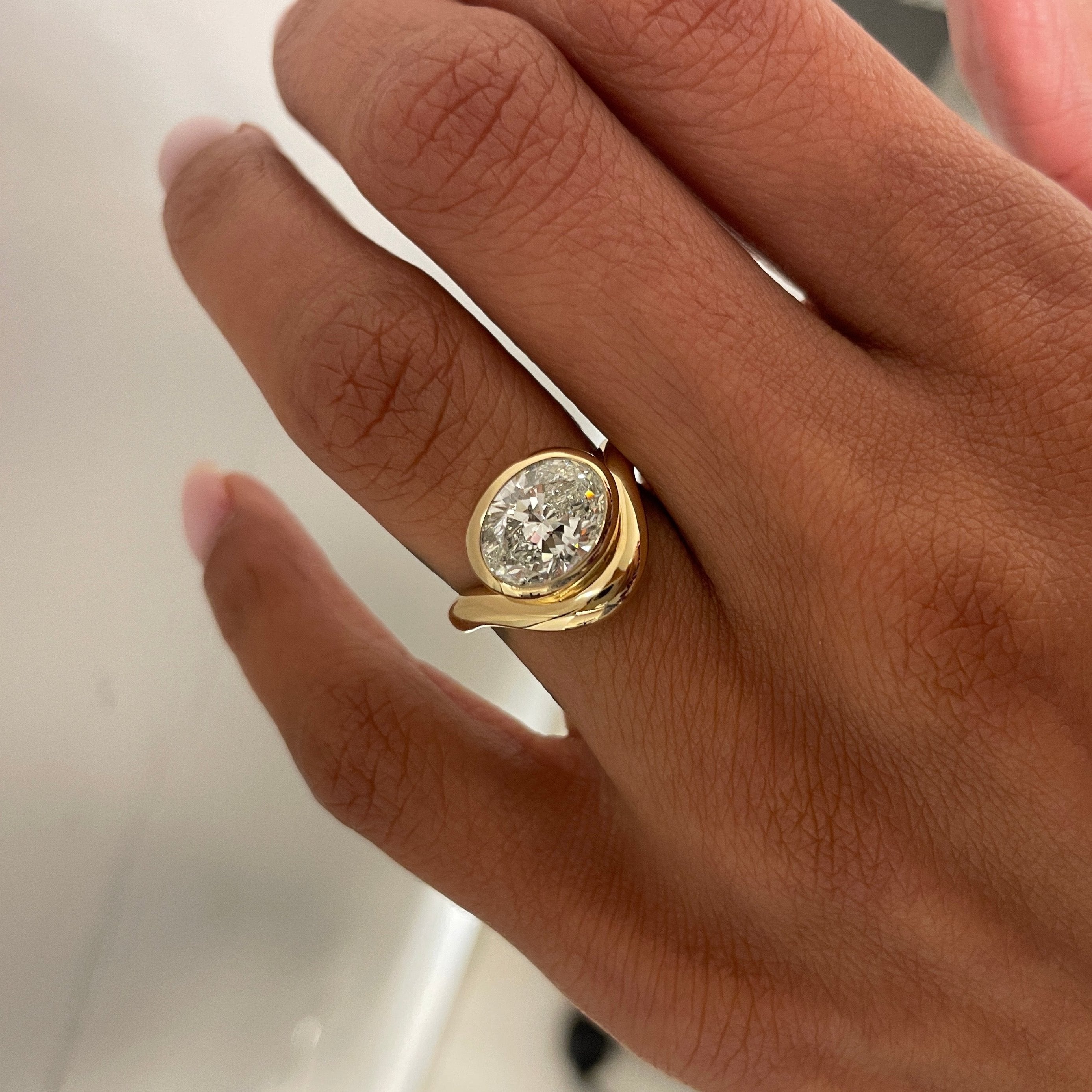 Bespoke White Oval Diamond DEEPA on hand
