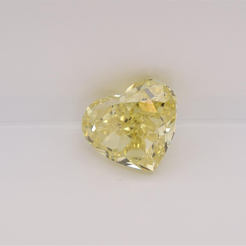 Heart-shaped yellow diamond on a light gray background