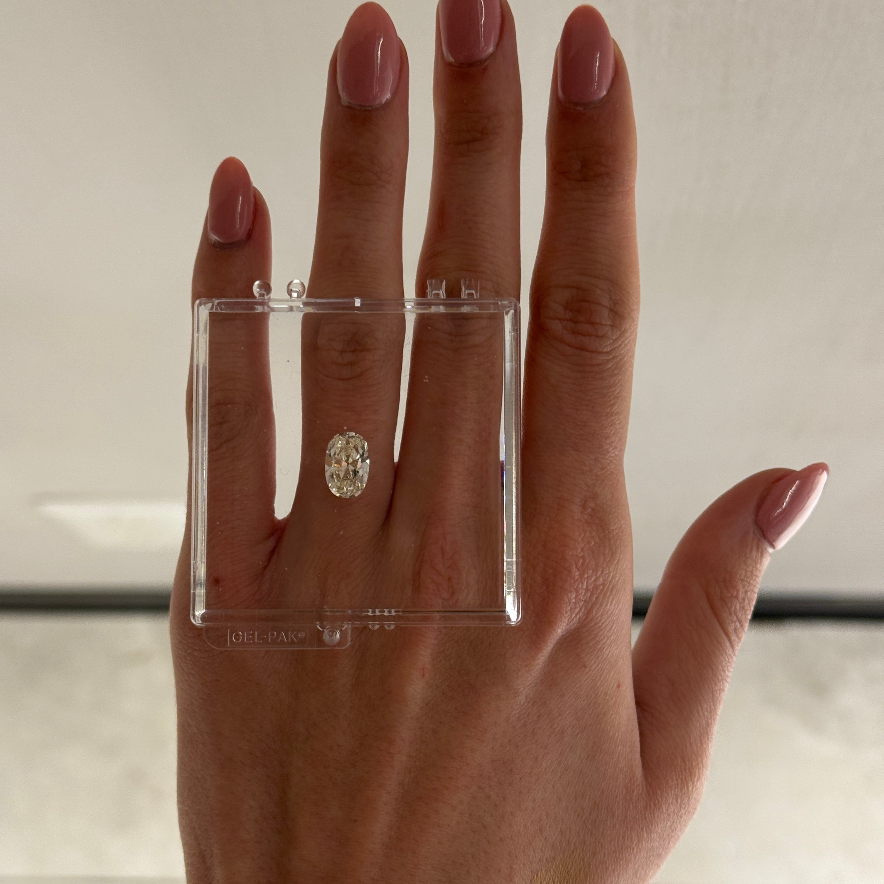 Loose 2.45 carat diamond laid over hand