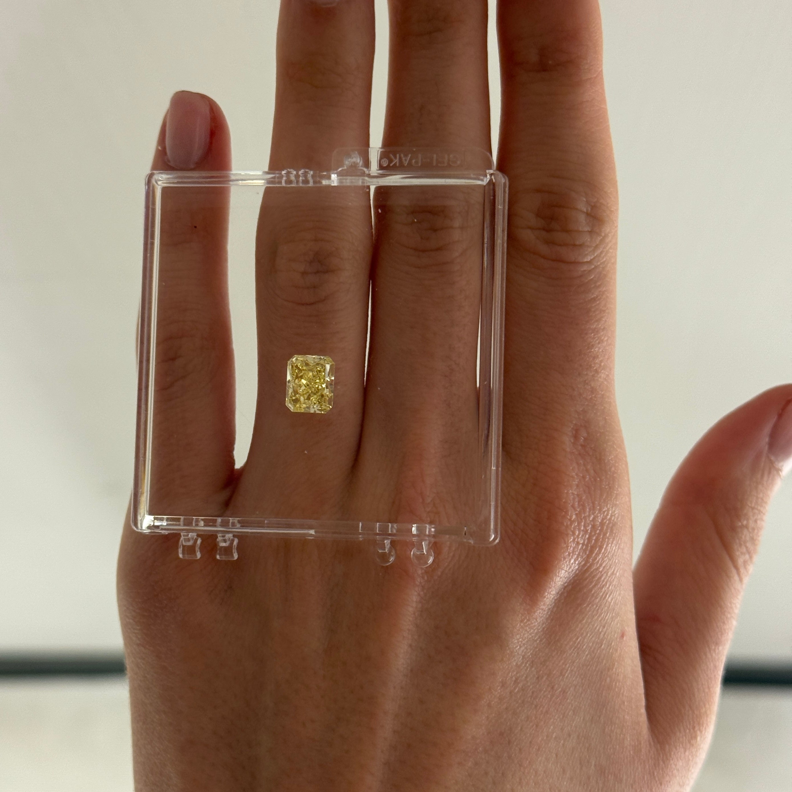 2.49 carat yellow diamond in a gel box on a hand