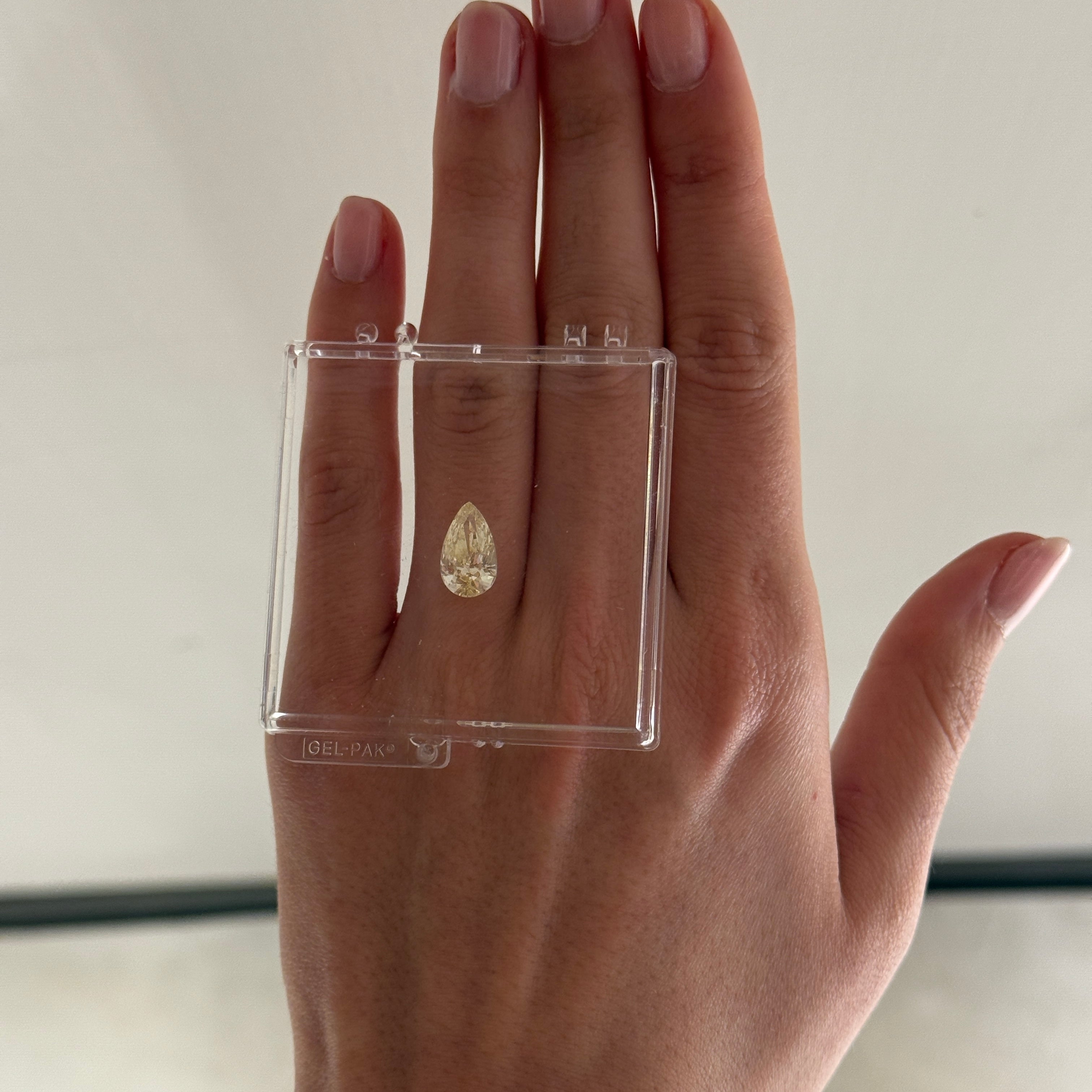 3.00 carat FY color pear cut diamond on a hand