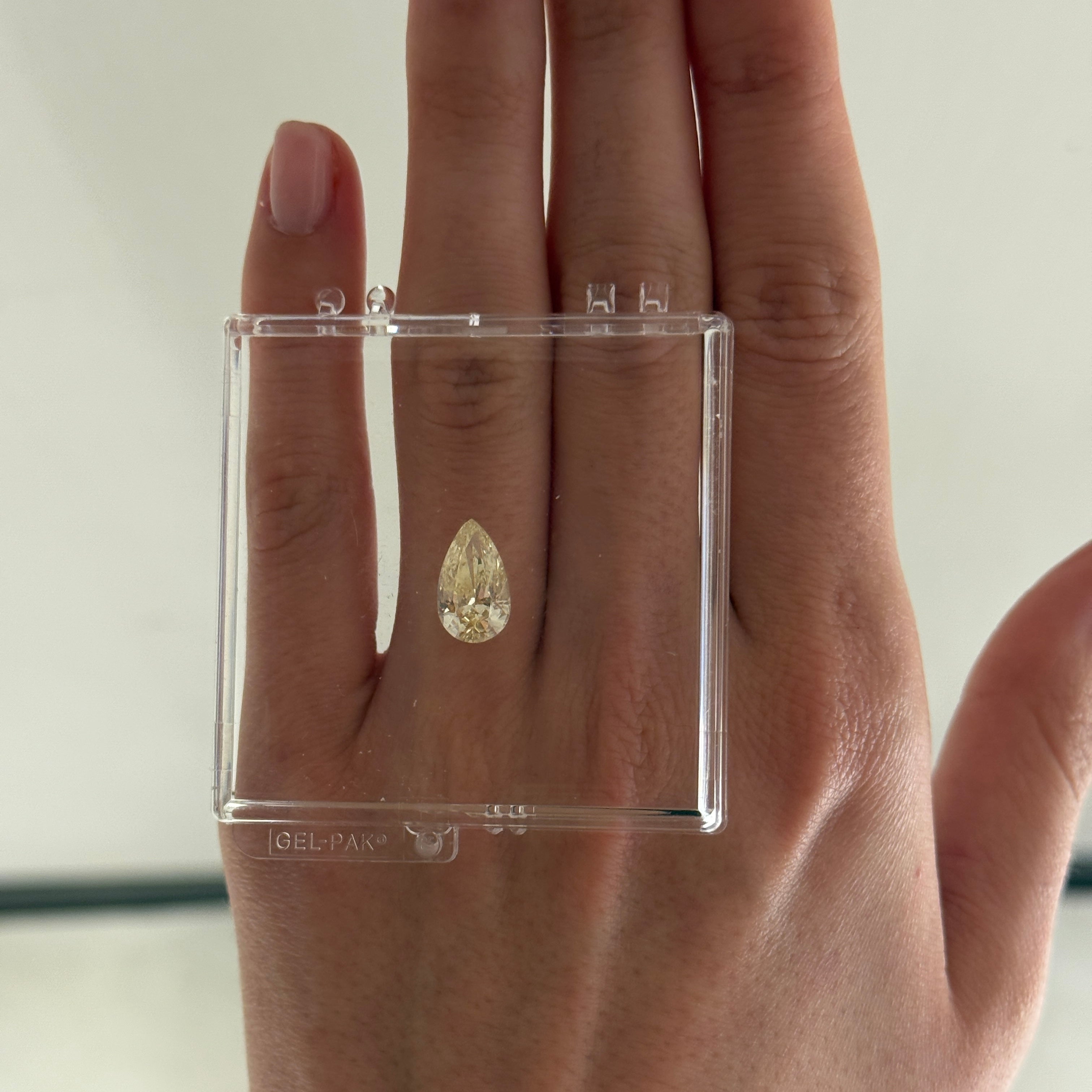 3.00 carat yellow pear diamond on a hand