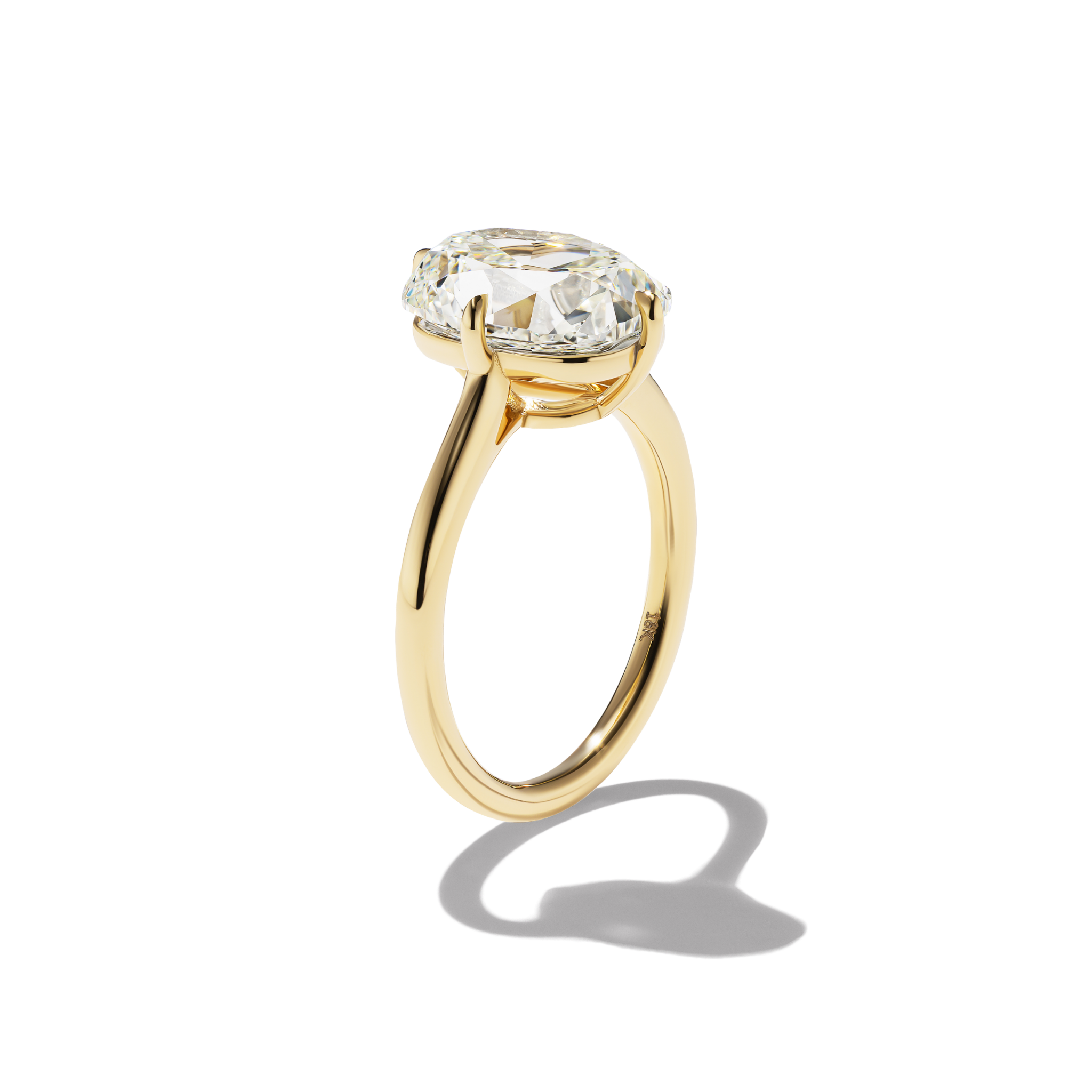 Gold ring with a large diamond on a white background