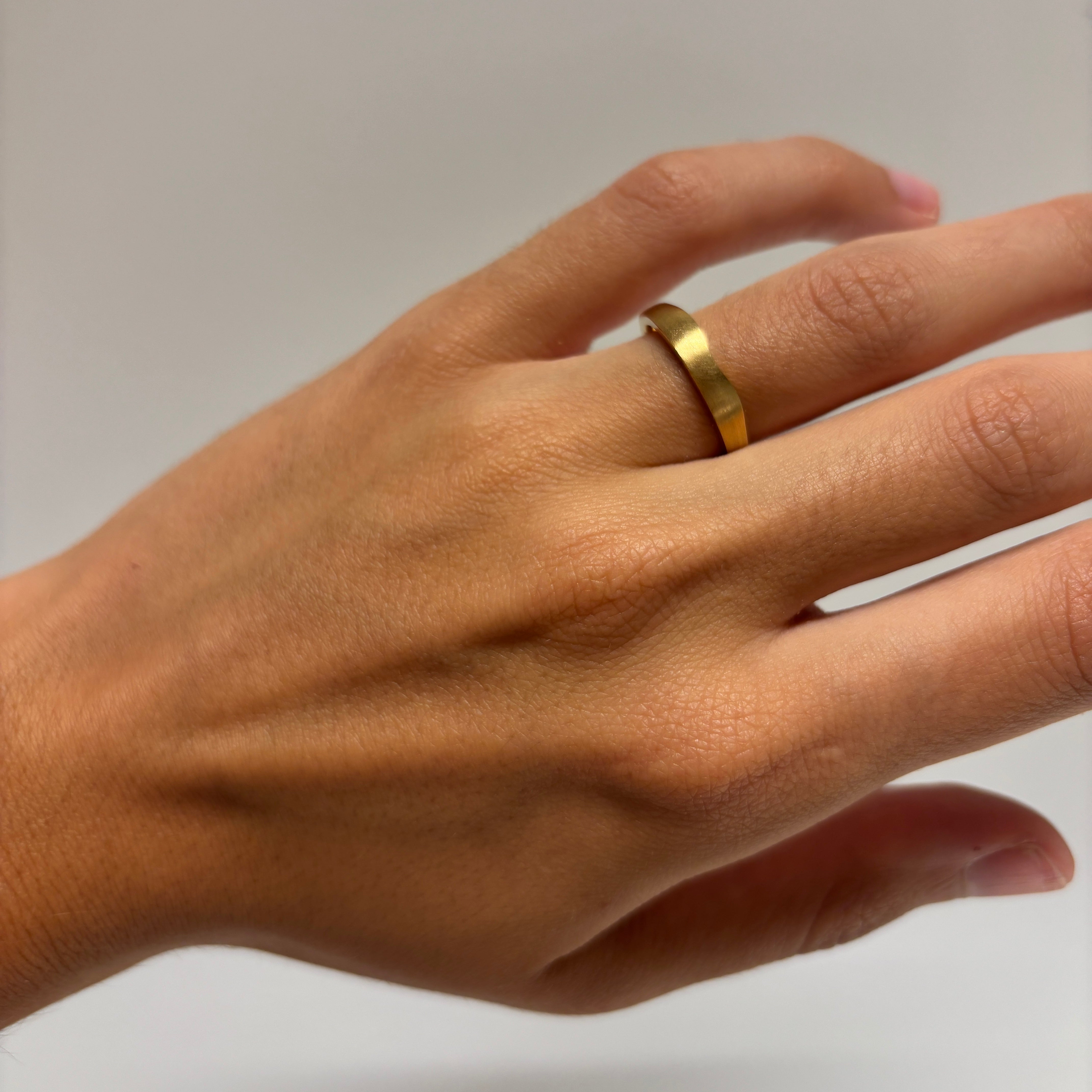 Twin Flame On Hand, yellow gold - satin finished, wave wedding band, on hand.