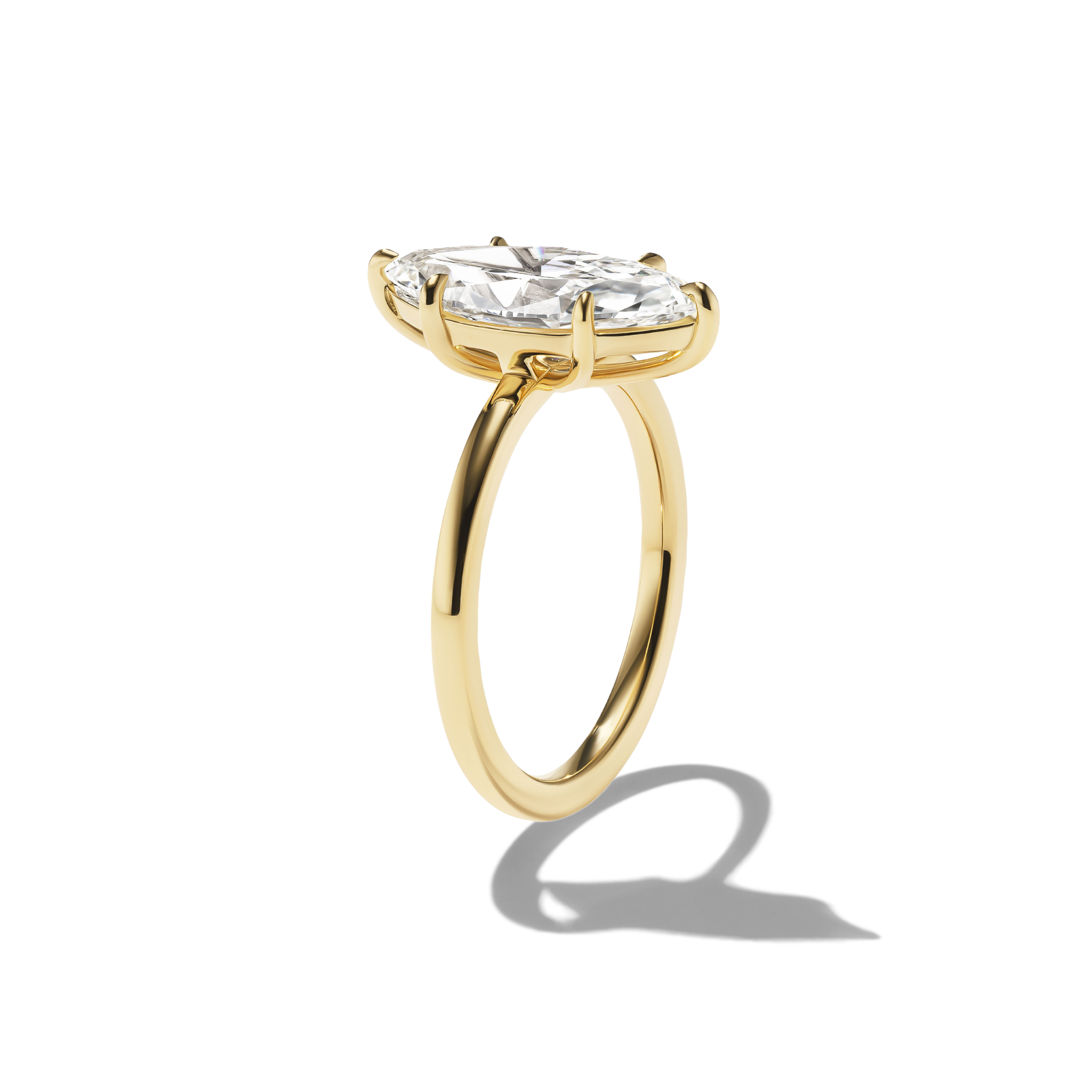 Gold ring with a large diamond on a white background
