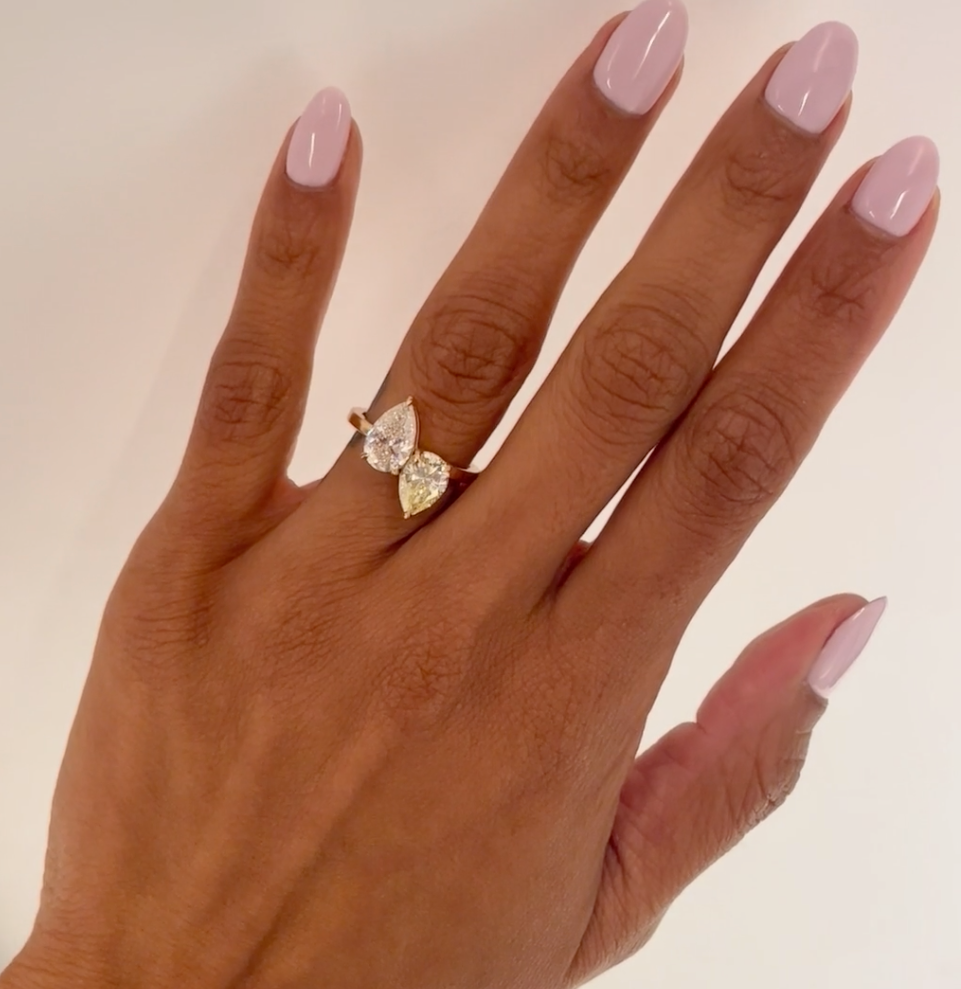 Yellow and White Pear Diamond Toi et Moi, worn on hand with White Pear cut diamond facing upwards, Yellow pear cut diamond facing downwards