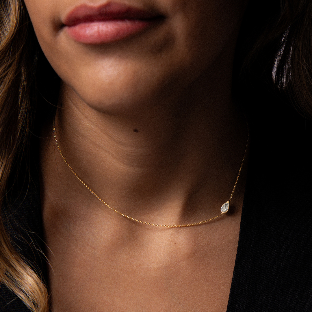necklace with white pear cut diamond on side
