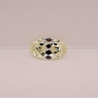 A single elongated oval-cut warm white diamond is set against a plain light pink background.