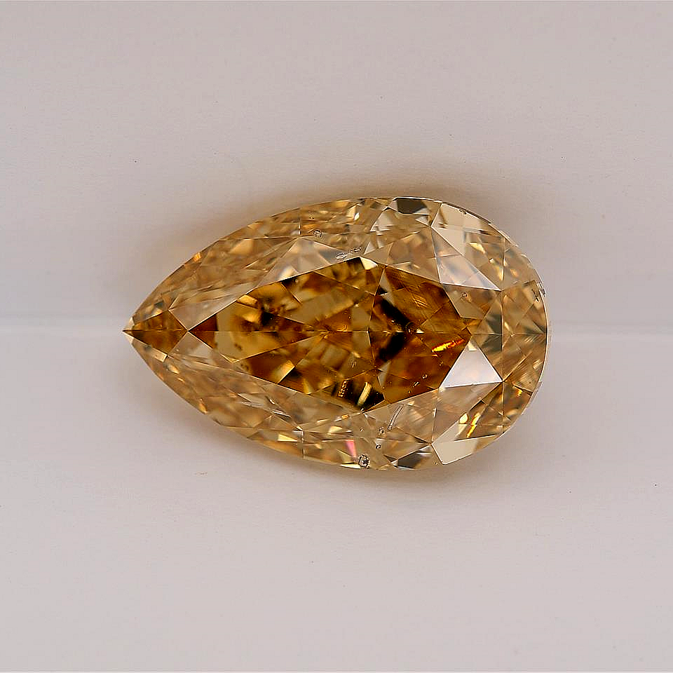 10.13 CRT FDBOY SI2 Pear-shaped brown diamond on a light gray background