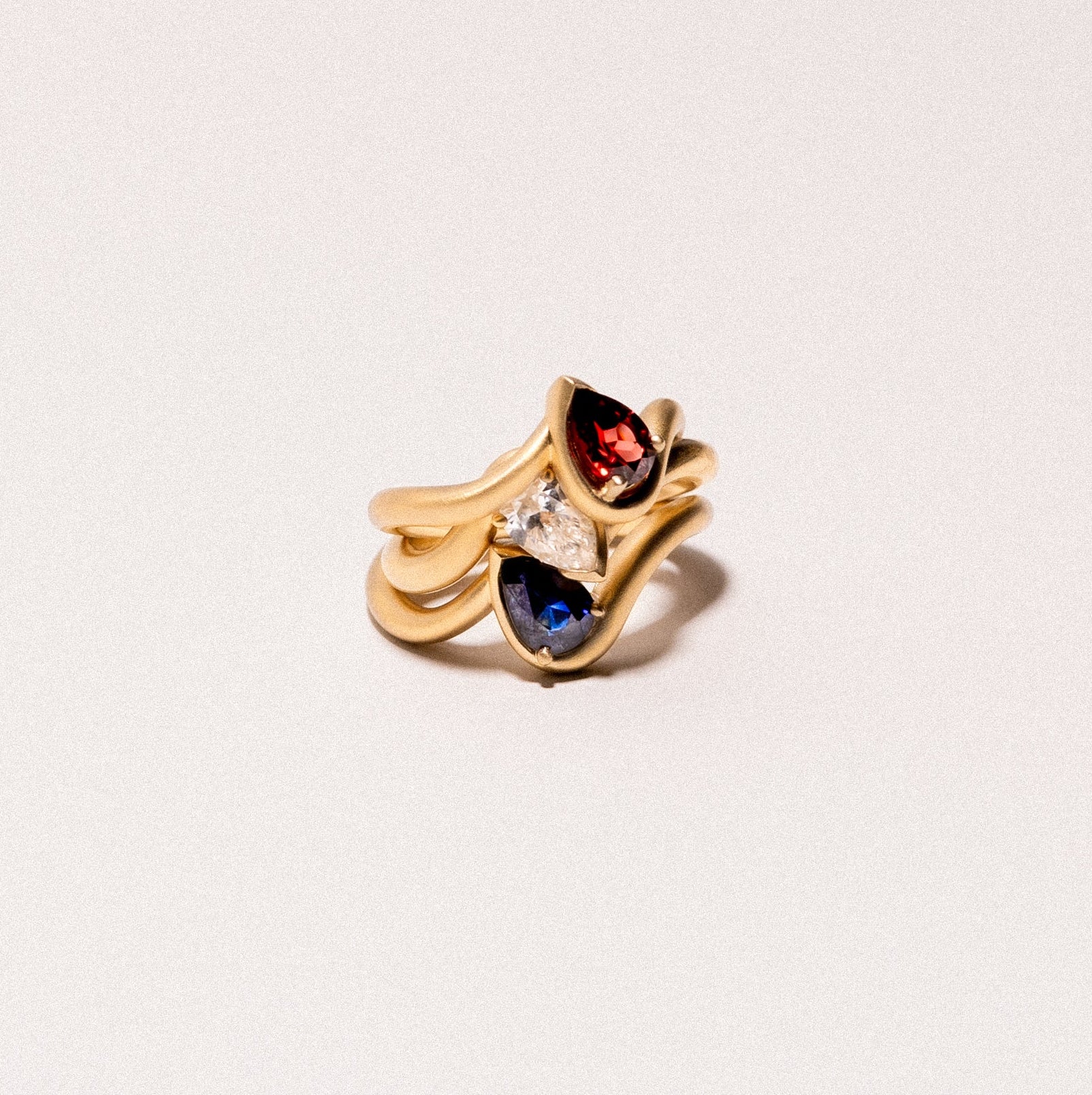 BB Thelma pinky ring stack in garnet, white sapphire, and blue sapphire