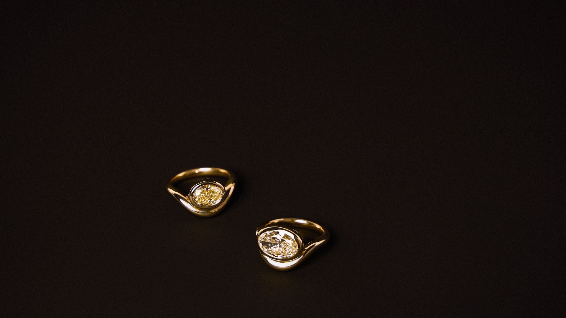 Gold ring and earrings on a black background