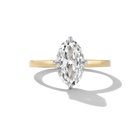 A classic diamond engagement ring featuring a marquise-cut center stone in a silver-toned setting on a yellow gold band, shown on a clean white background with a soft shadow.
