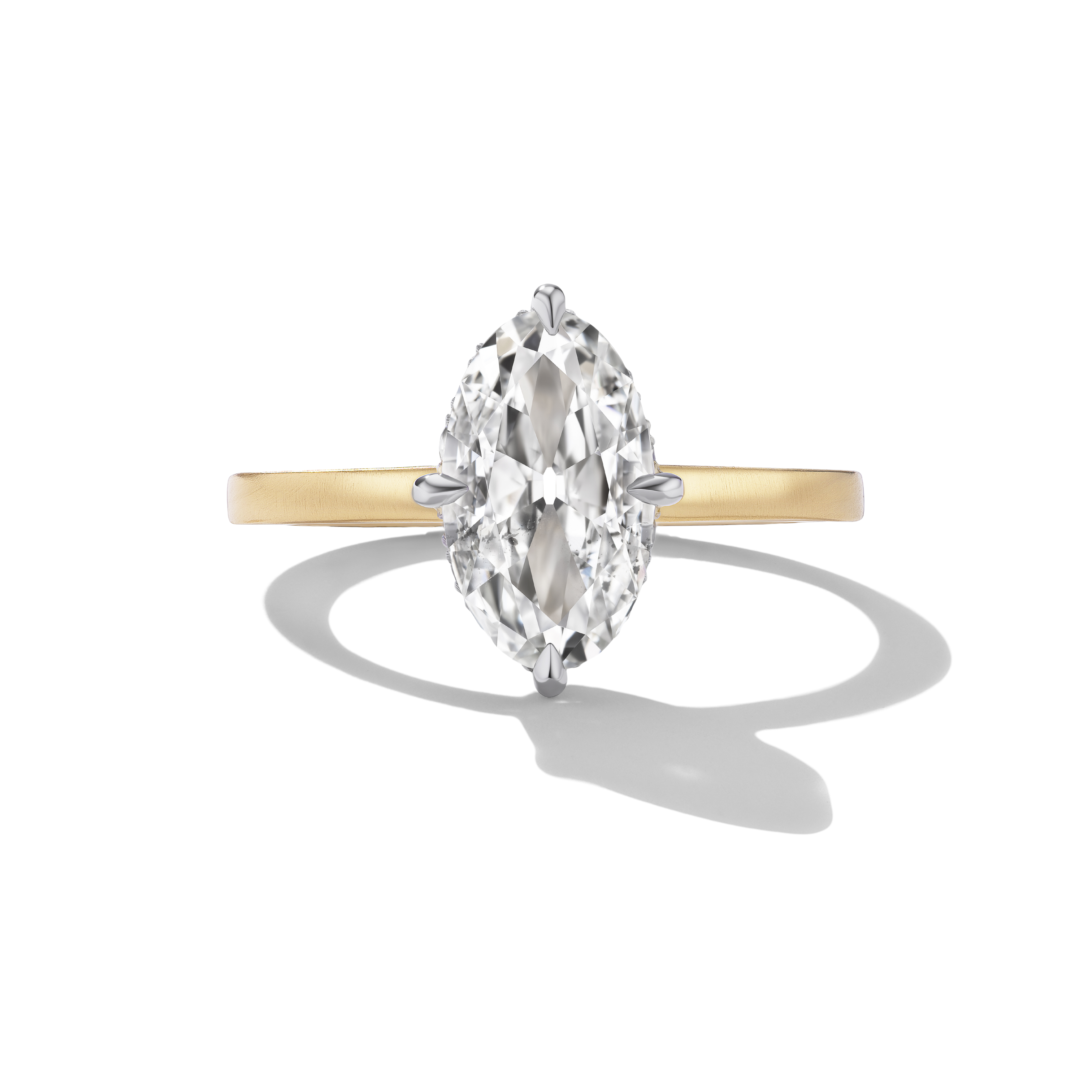 A classic diamond engagement ring featuring a marquise-cut center stone in a silver-toned setting on a yellow gold band, shown on a clean white background with a soft shadow.