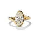 Gold ring with a pear-shaped diamond on a white background
