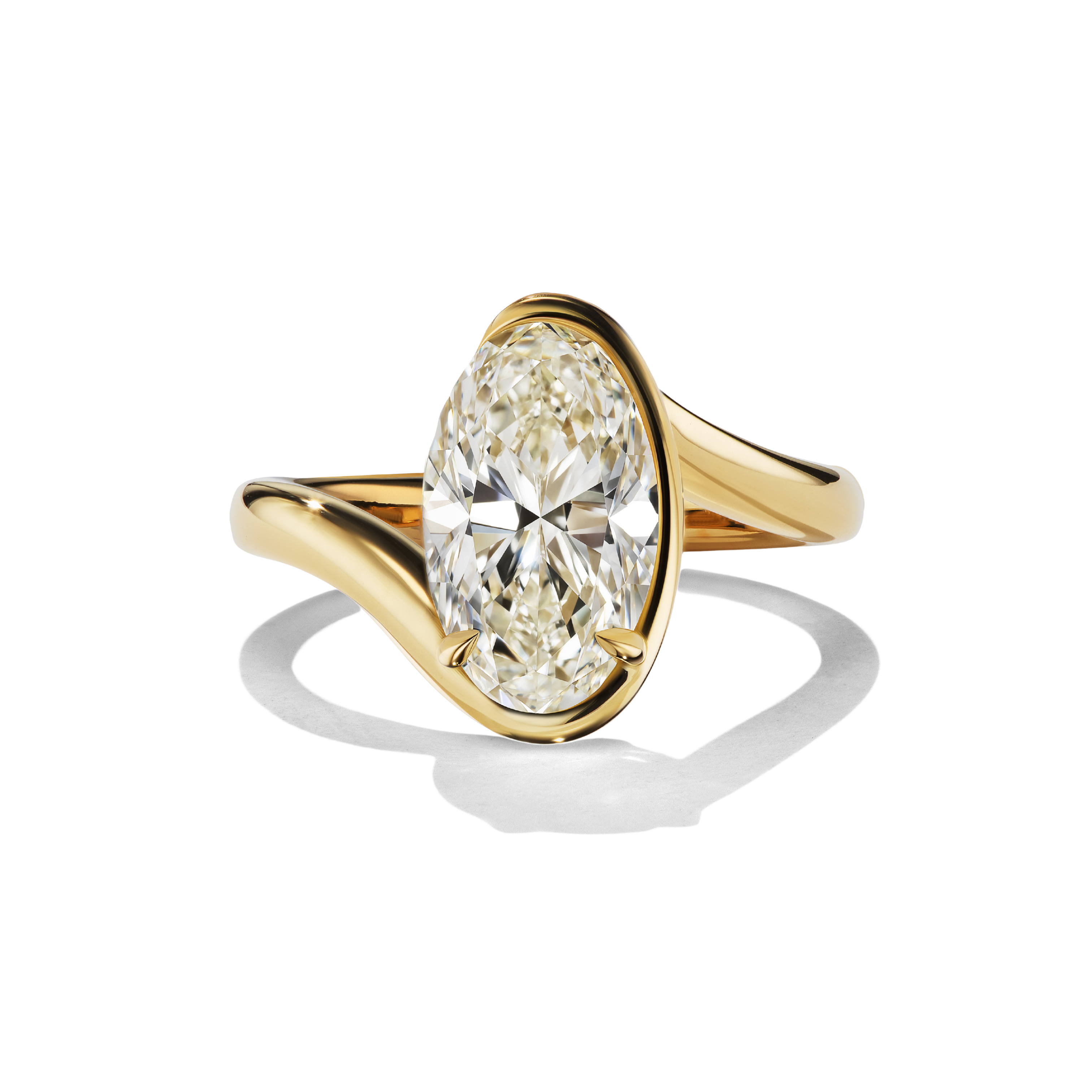 Gold ring with a pear-shaped diamond on a white background