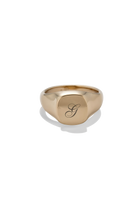 A polished gold signet ring with a raised square face engraved with a cursive letter 'G', shown on a clean white background with a soft shadow.