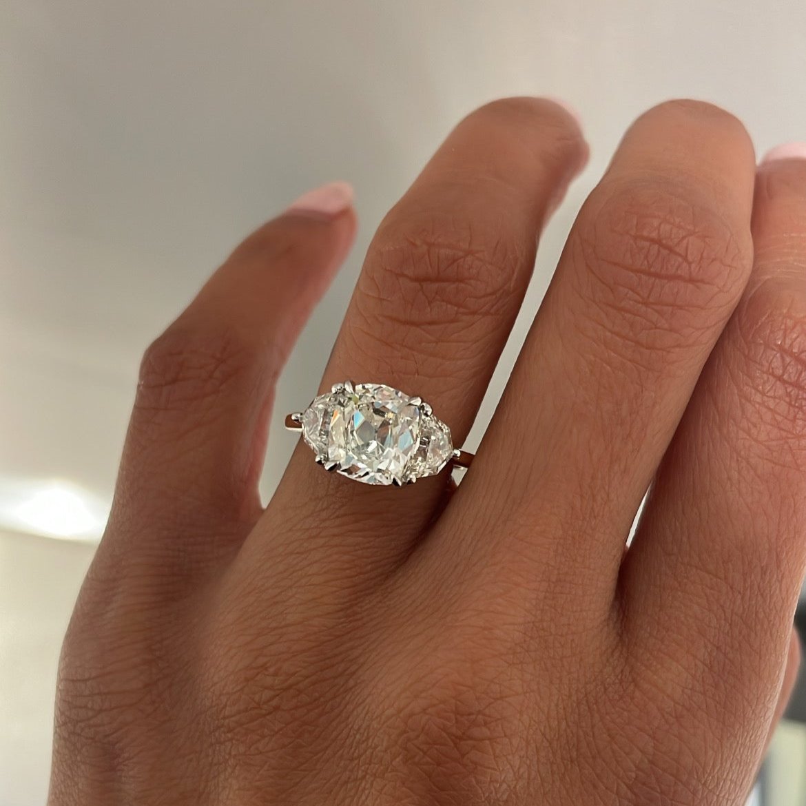 Cushion Cut Three Stone Ring on Hand