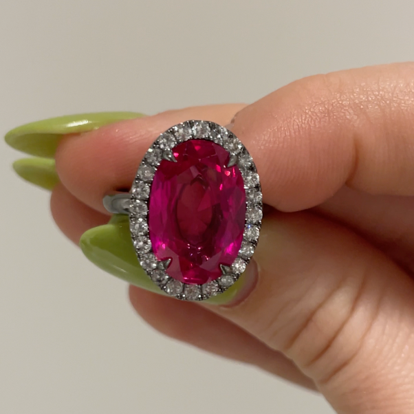 Fancy Vivid Pink Diamond Cocktail Ring, Halo in Black Rhodium, held between fingers