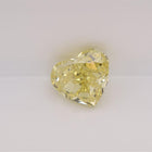 Heart-shaped yellow diamond on a light gray background