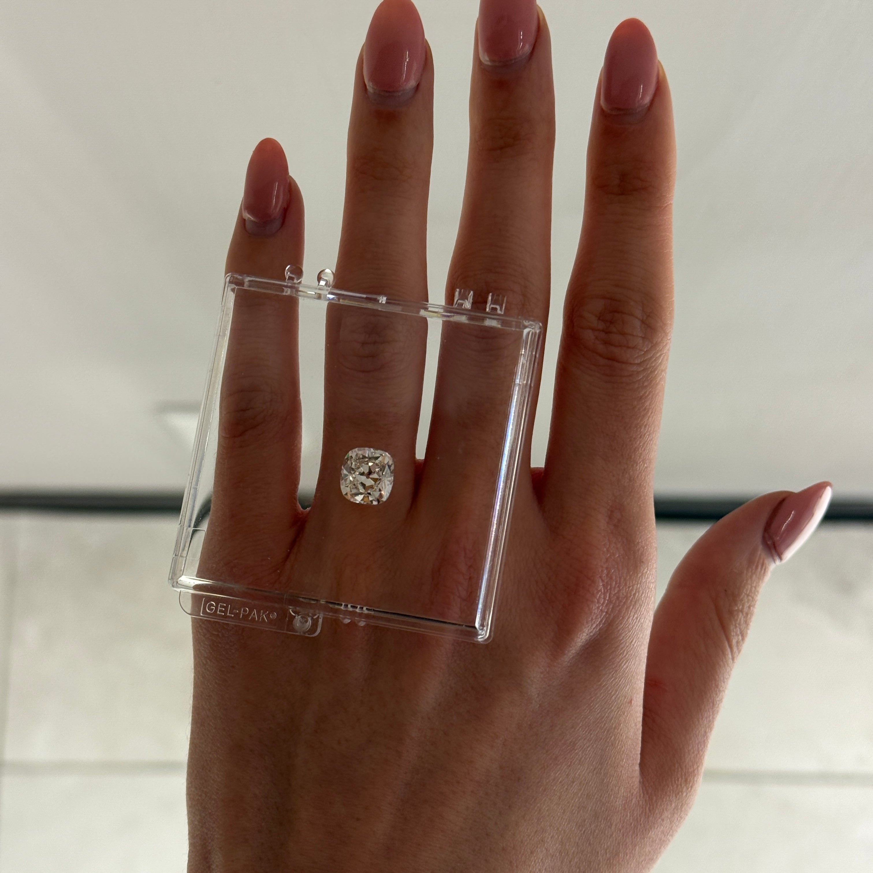 diamond in gel box balanced on female hand
