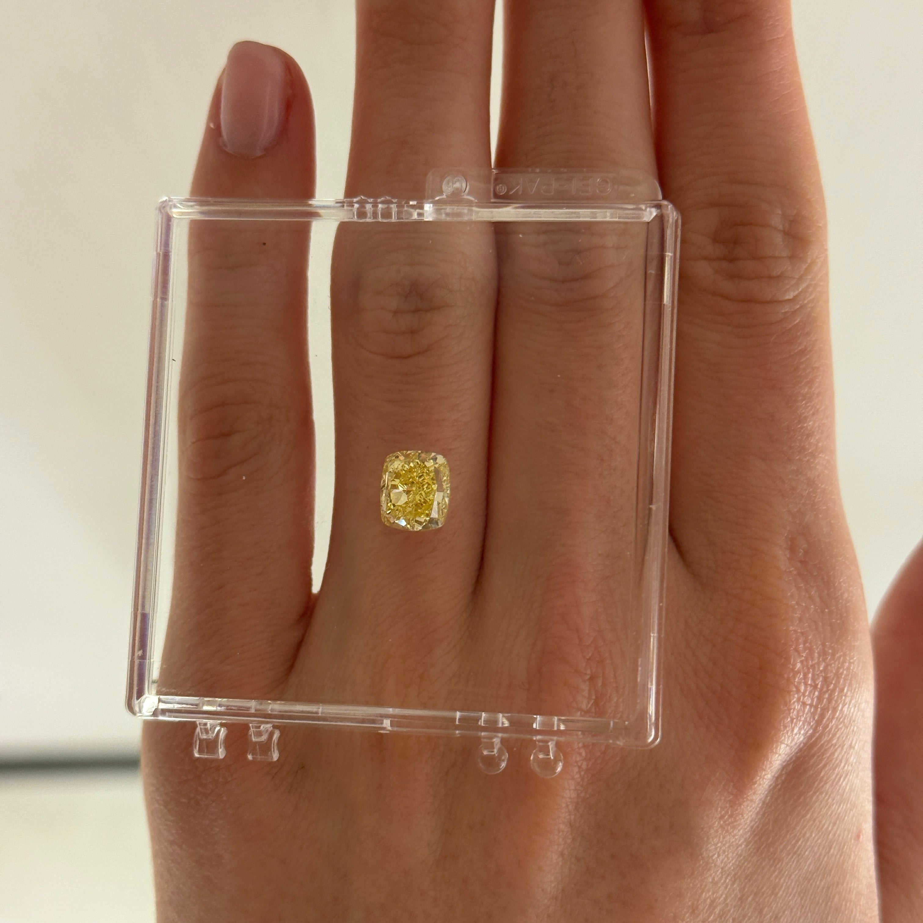 2.74 crt cushion modified brilliant yellow diamond on a hand
