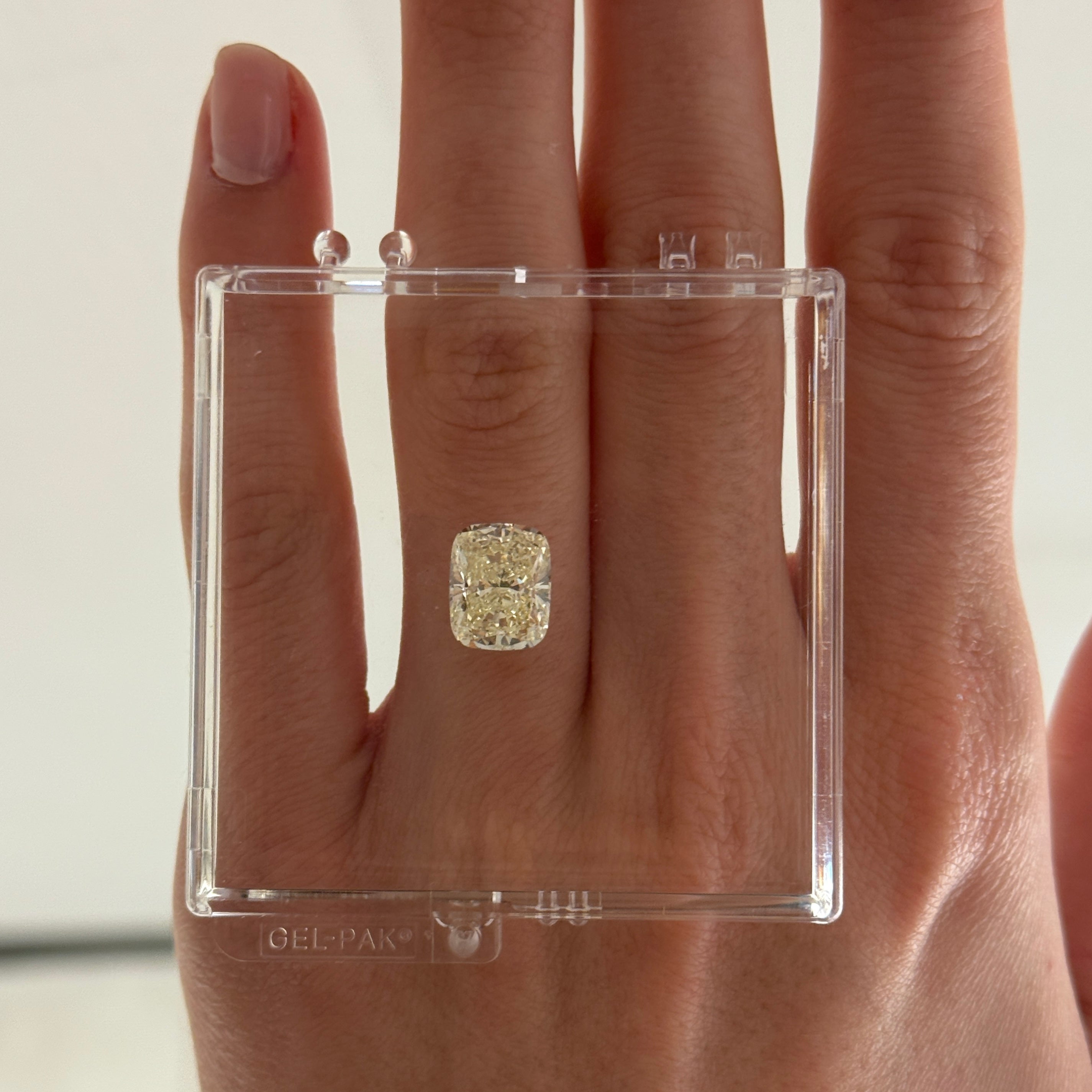 4.01 crt yellow cushion brilliant cut diamond shown in gel box on hand
