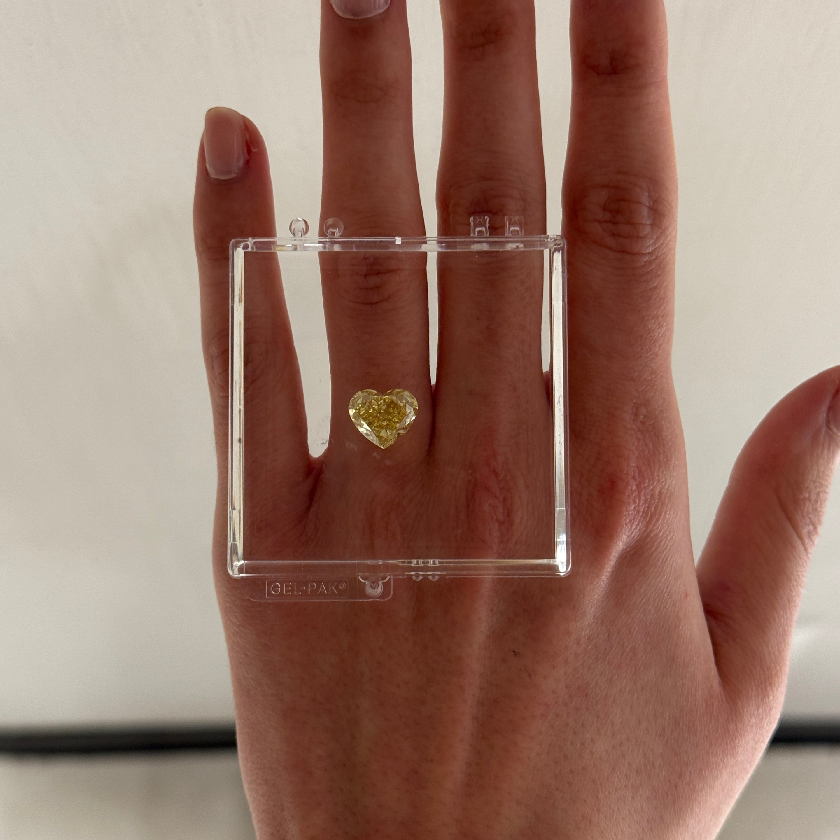 fancy yellow heart shape diamond in gel box on hand