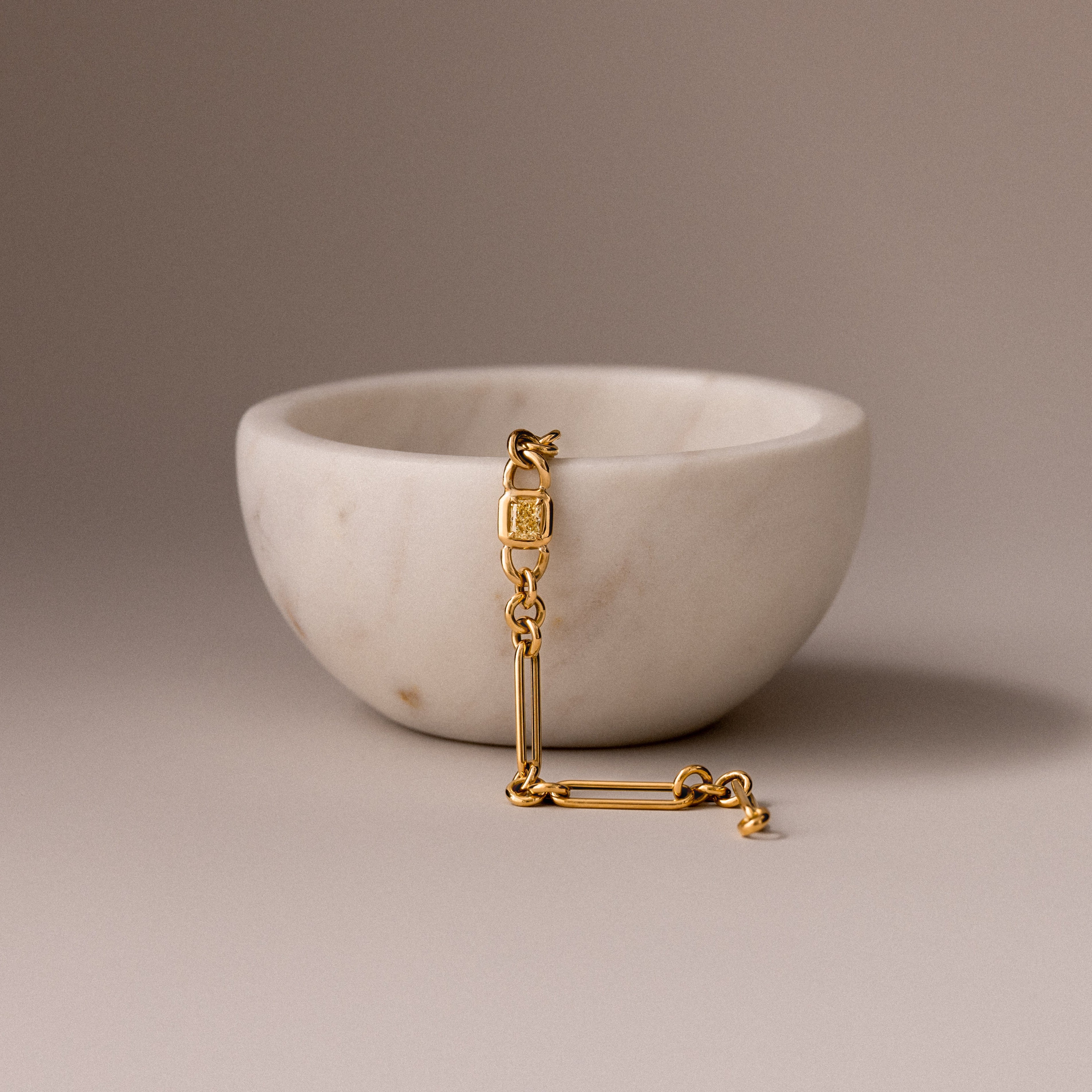 Our Marici, Yellow Diamond Bracet in a marble bowl