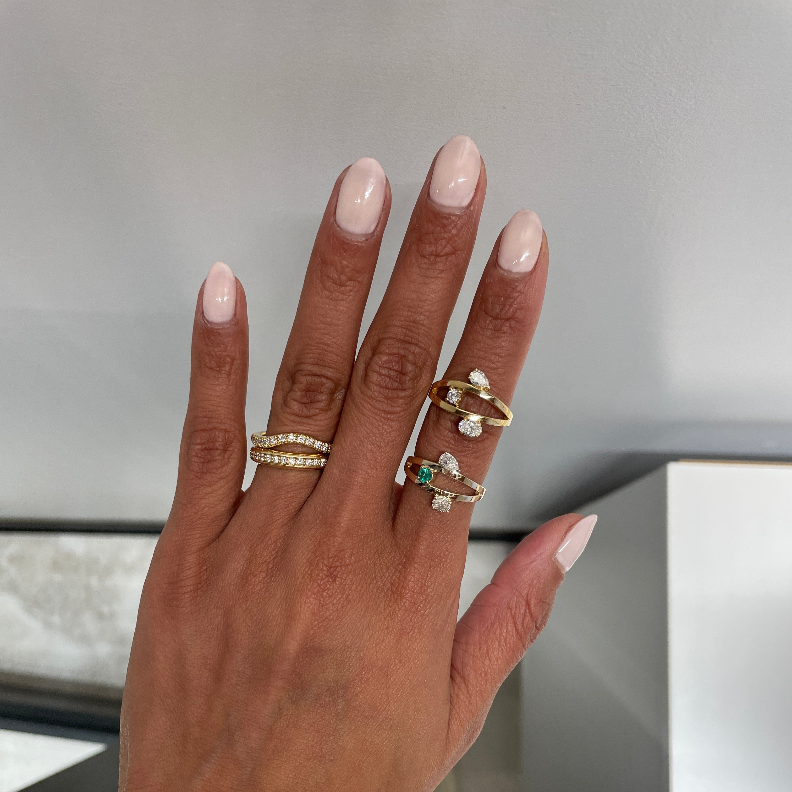 Modified COSMO with Emerald on finger with original COSMO and Eternity bands