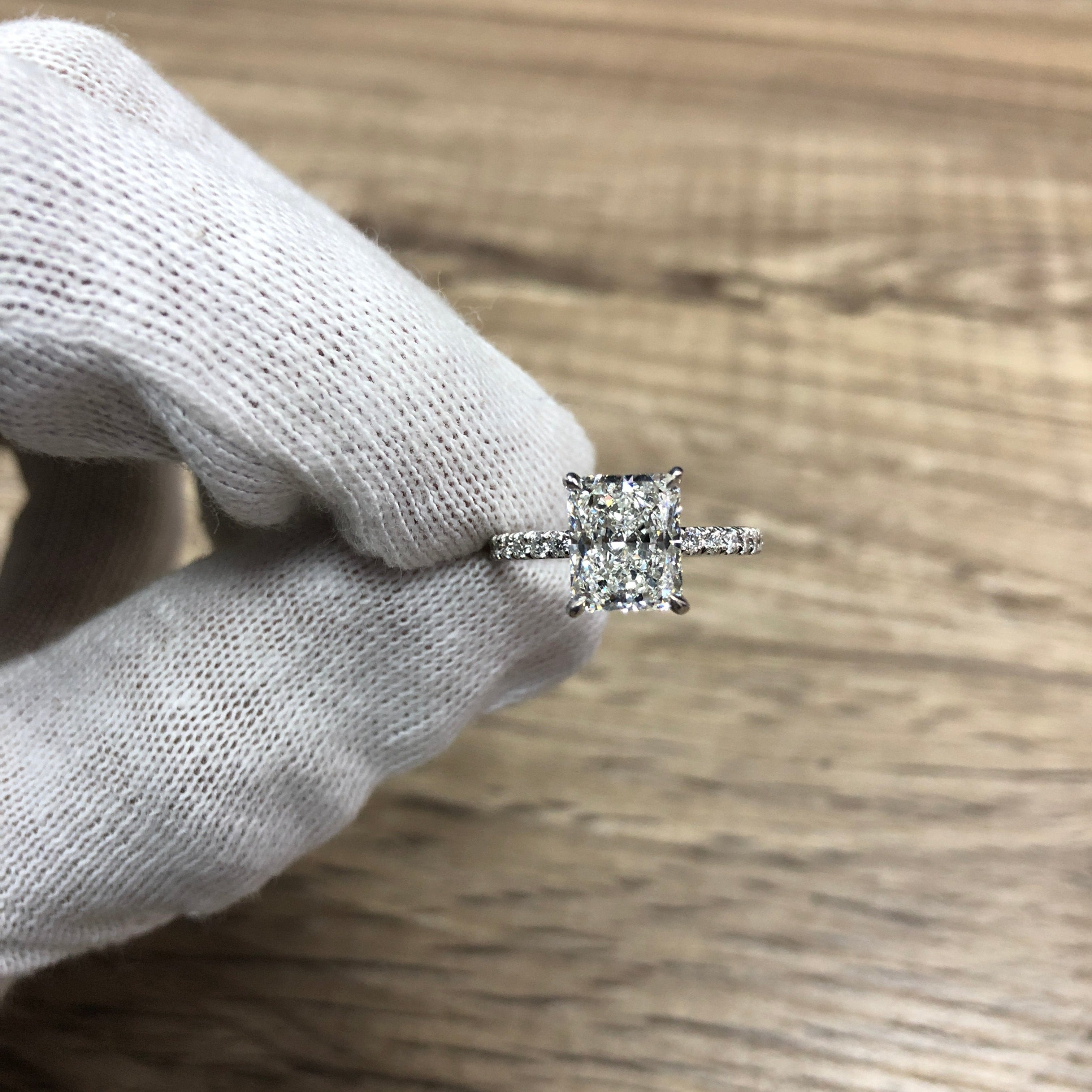 Radiant Cut Diamond on Pavé Band, held