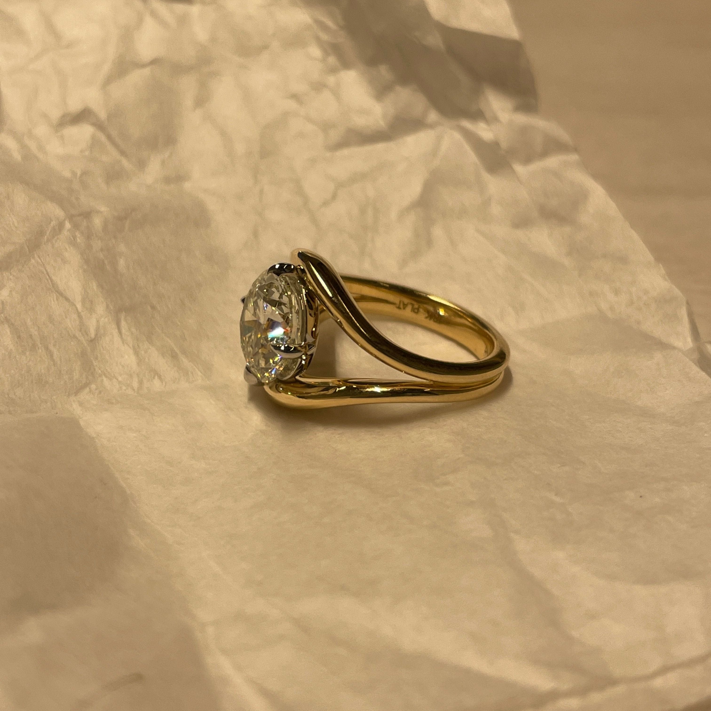 Round Diamond in a Split Shank Band, on table