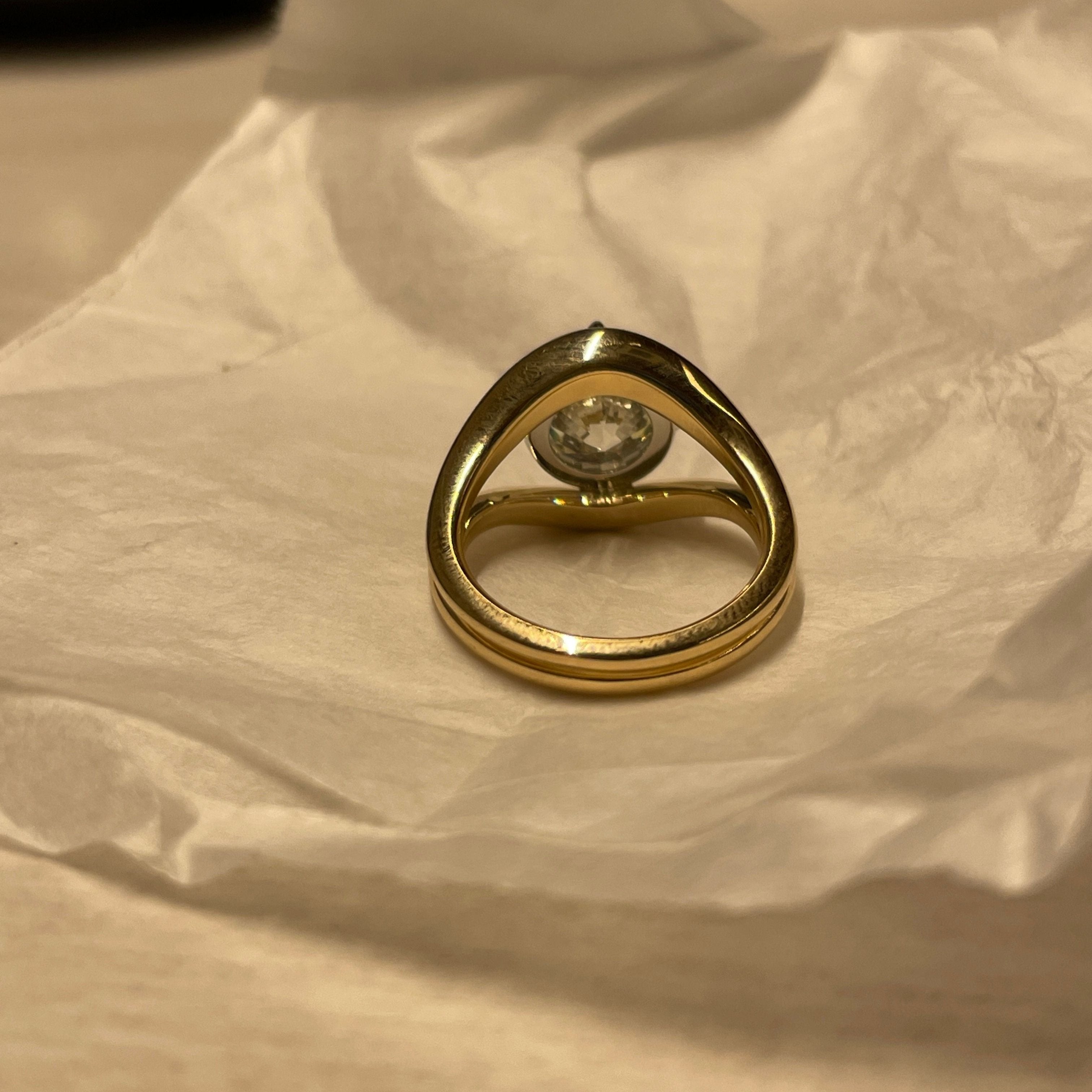 Round Diamond in a Split Shank Band, on table, back view