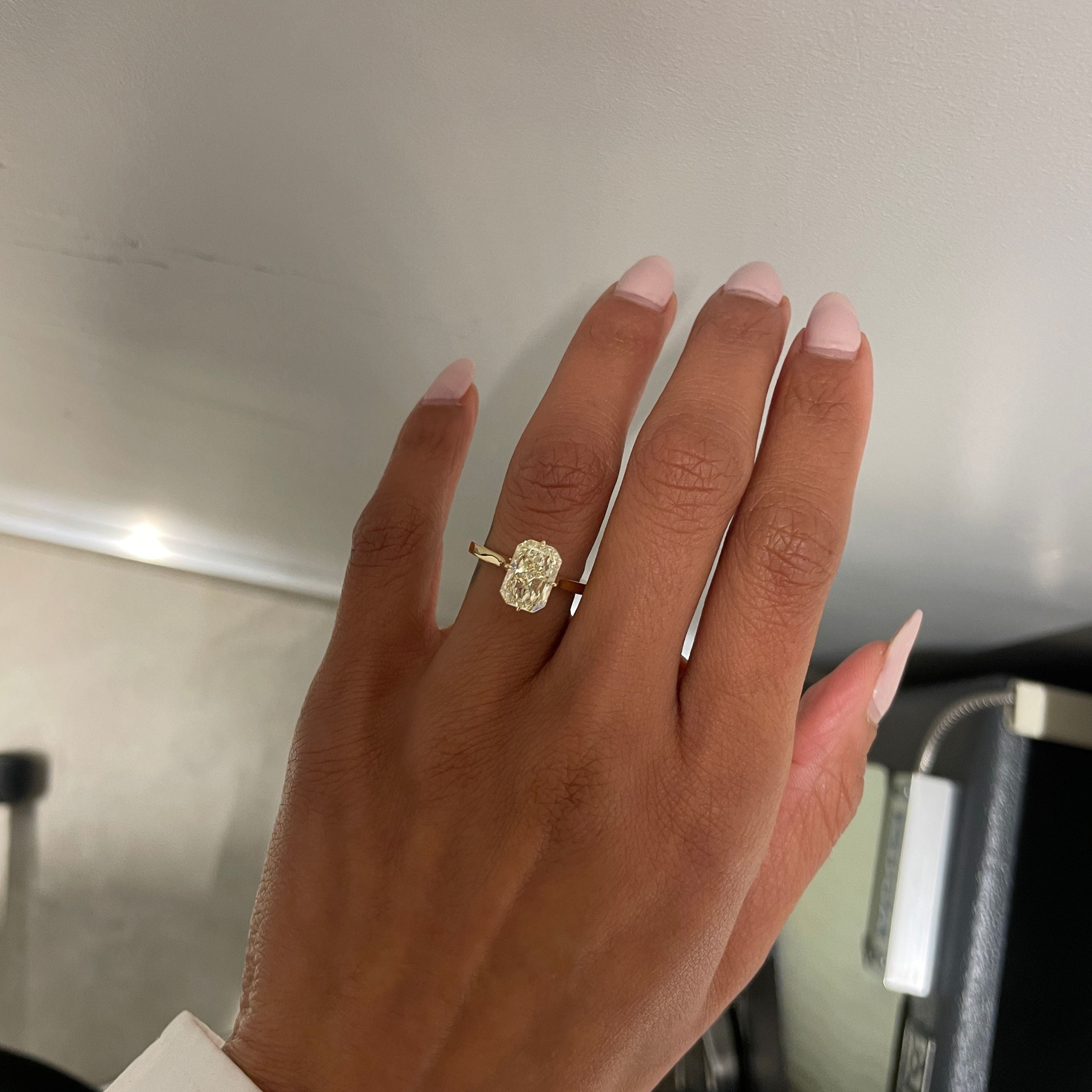 Yellow Radiant Cut Solitaire, on finger