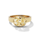 An 18KT yellow gold ring with a large oval yellow diamond centerpiece and a hidden halo of smaller diamonds around it.