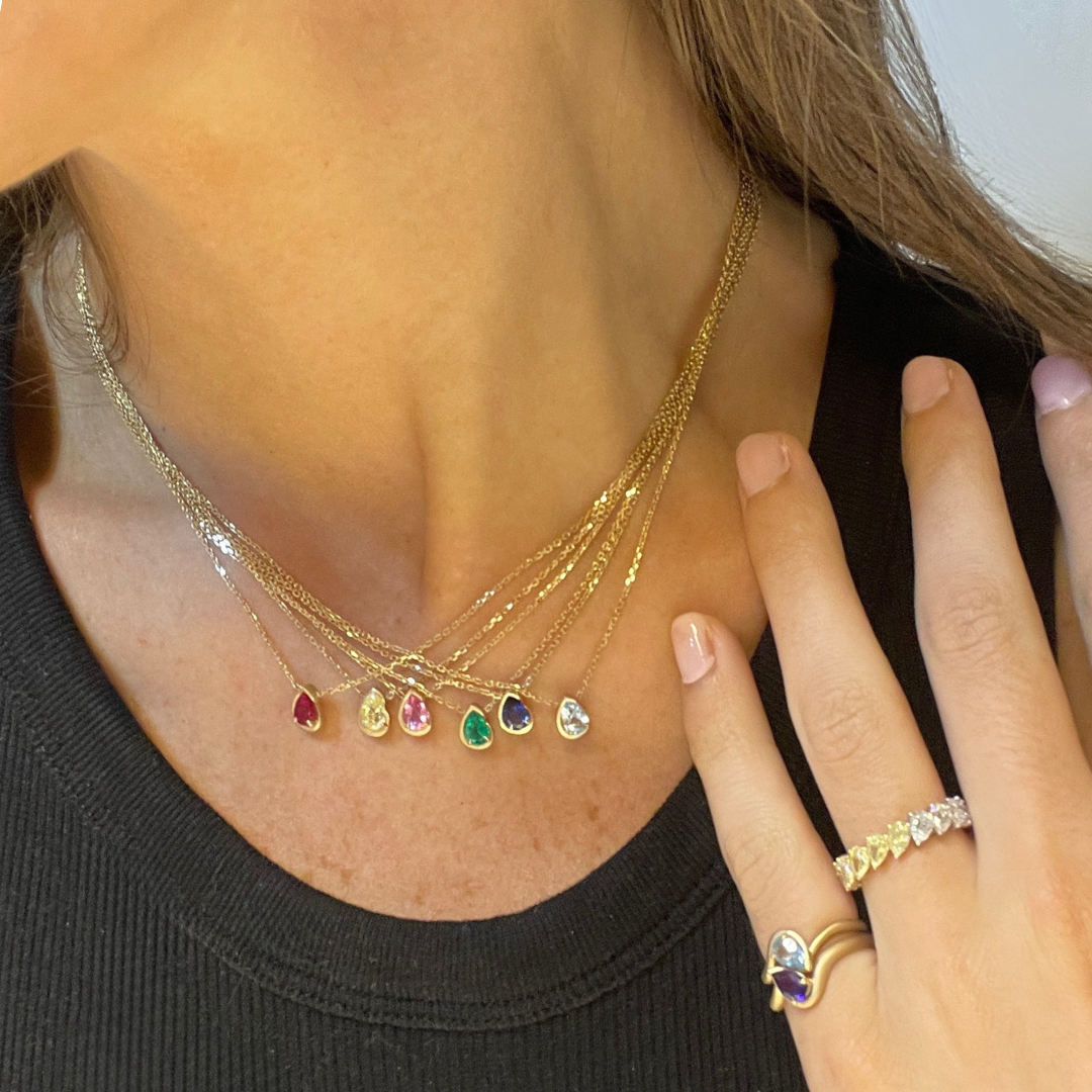 Model wearing multiple BB Thelma necklaces in 14k yellow gold