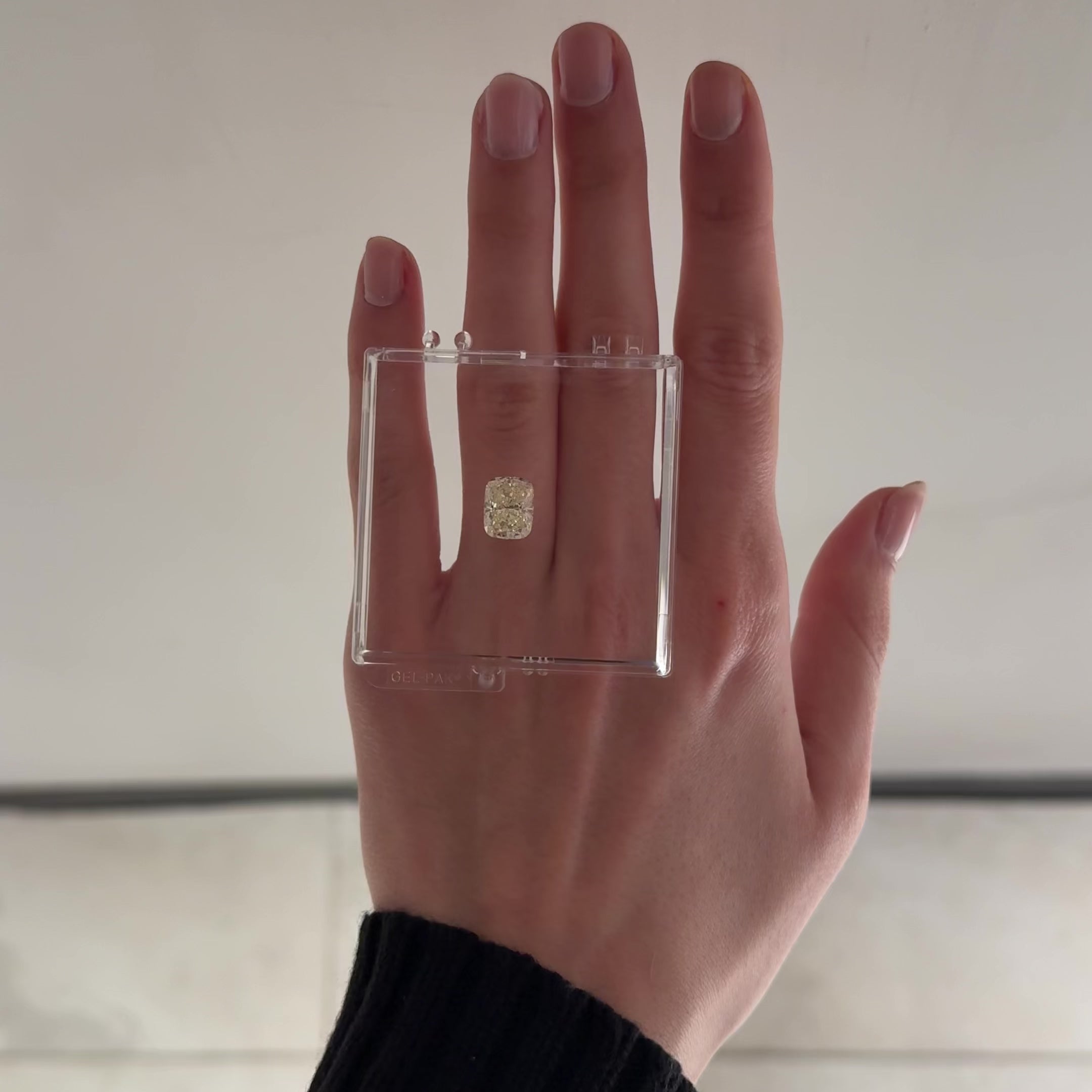 4.01 crt yellow cushion brilliant cut diamond shown in gel box on hand moving back and forth