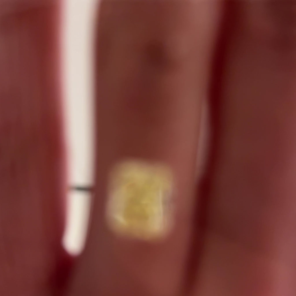 2.49 carat yellow radiant cut diamond in a gel box on a hand