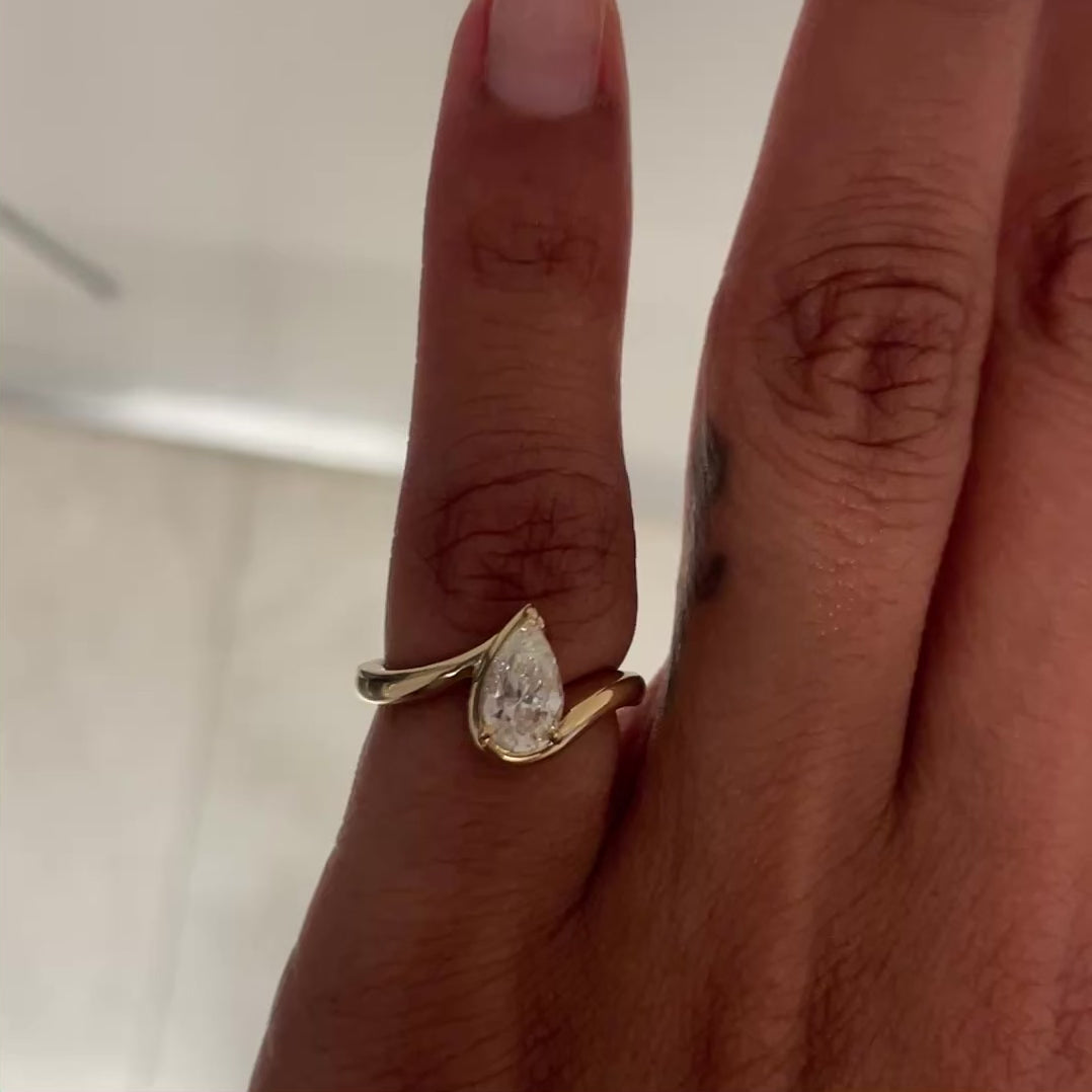 Video of hand model wearing BB Tala in 14k yellow gold on left hand pinky in front of a white wall.