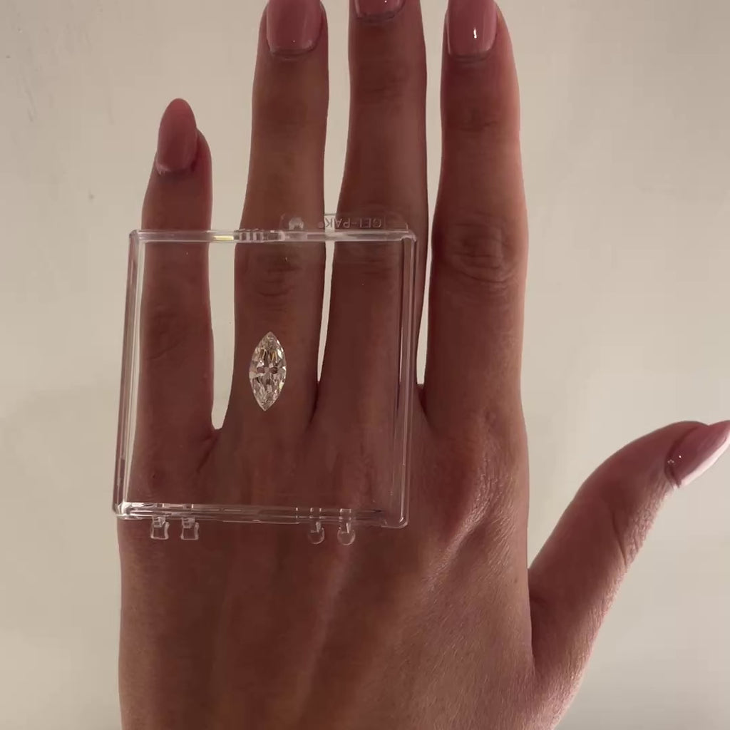 loose marquise diamond shown resting on a hand