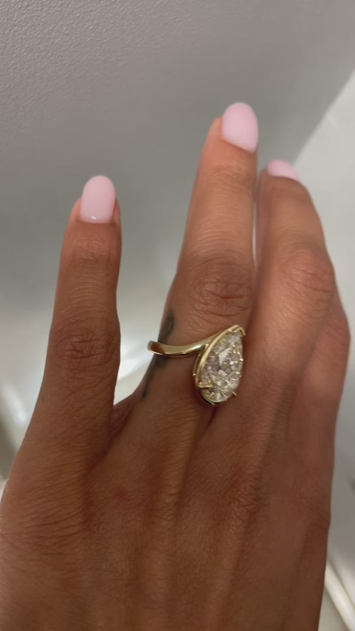 Bespoke TALIA engagement ring with faint brown pear cut diamond, satin finish 18kt yellow gold, on model