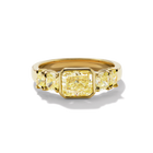Quinn Engagement ring, A bezel set radiant cut yellow diamond ring with cushion-cut side stones in yellow gold.